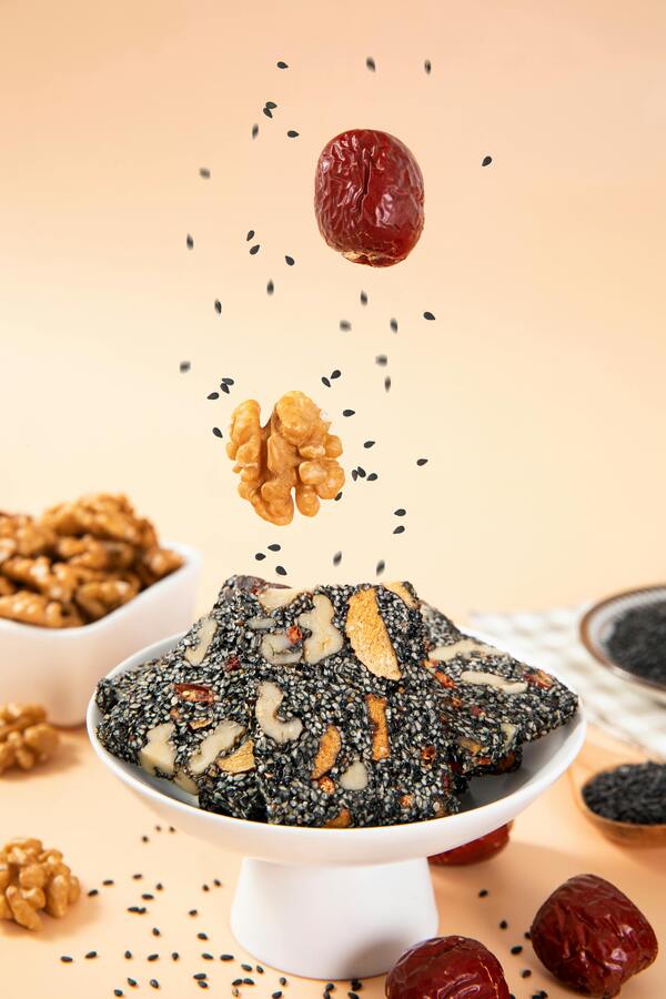 A person grabbing a no-bake energy bite from a container before heading out the door.