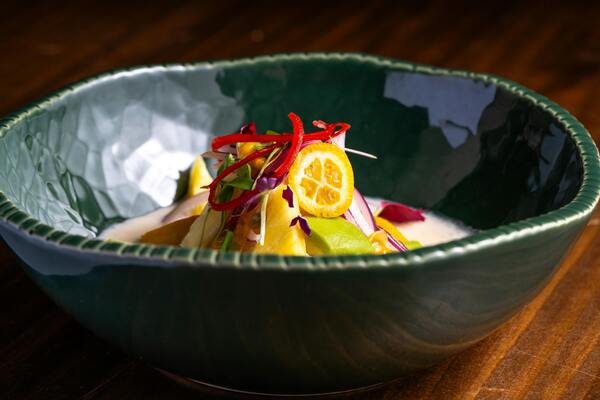 A display of foods rich in different vitamins: oranges for C, carrots for A, almonds for E, and salmon for D.